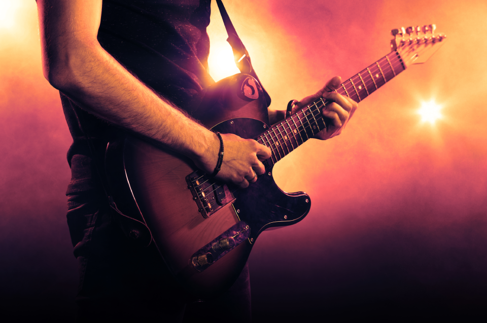 Guitarist playing electric guitar on stage