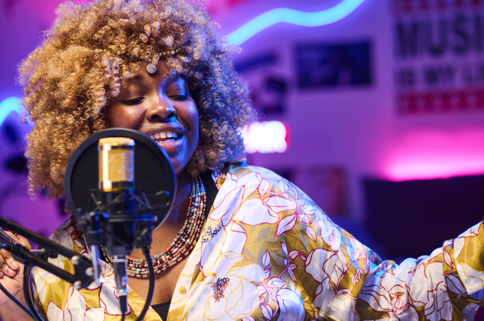 Singer recording in colorful music studio