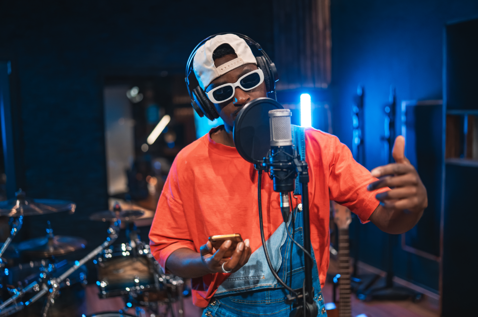 Recording artist rapping into microphone in studio